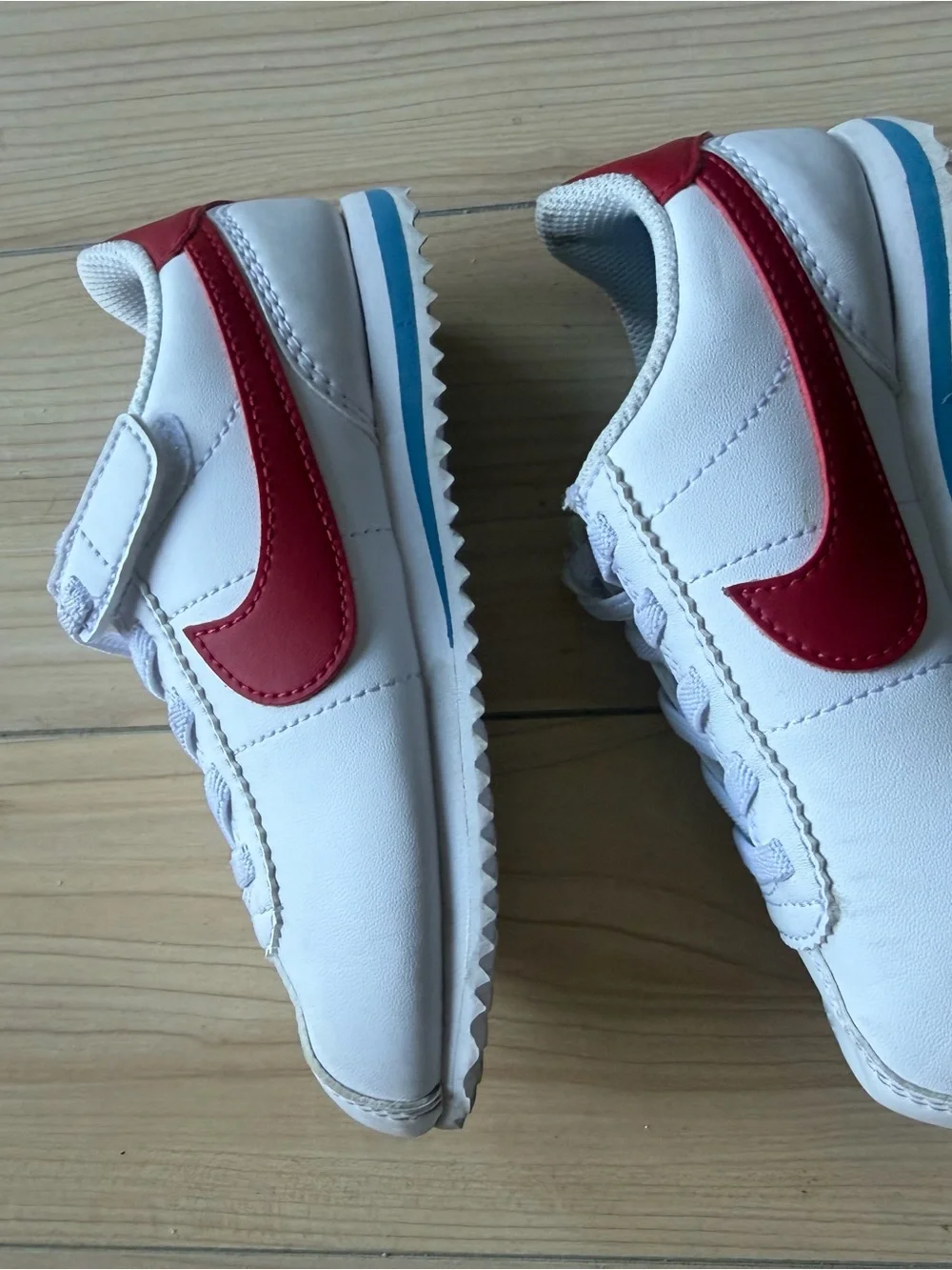 Nike Kids White Sneakers with Red Swoosh